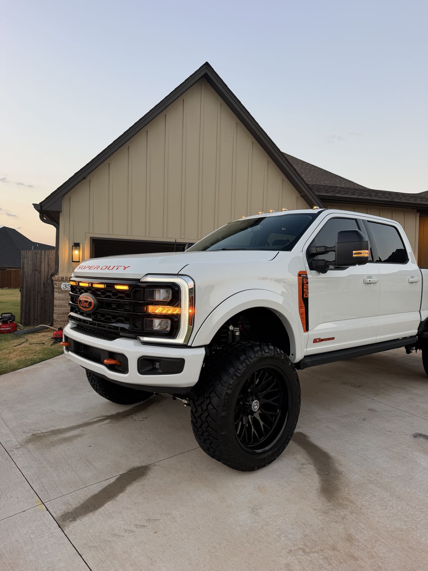 Lifted Ford Super Duty finished at golden hour on an Edmond driveway